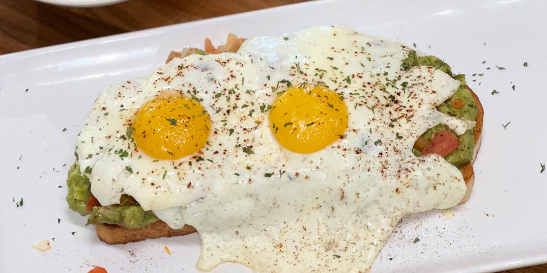 Avocado toast topped with two cage-free eggs made famous by ERA Cafe, the best breakfast in Arbor Vitae Wisconsin