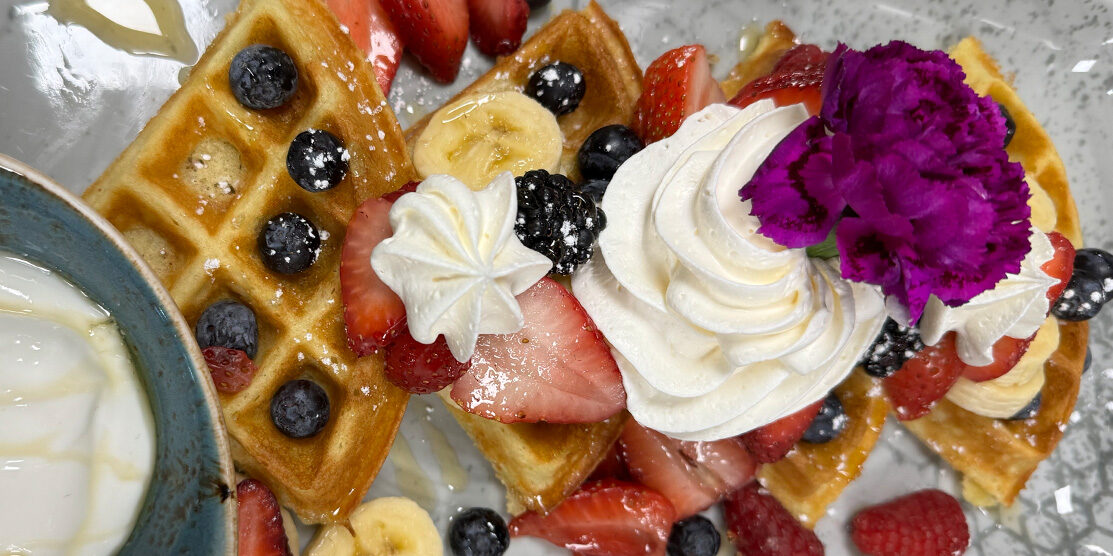 Waffles topped with fresh bananas and blueberries, made famous by ERA Cafe, offering the best breakfast in Arbor Vitae, WI